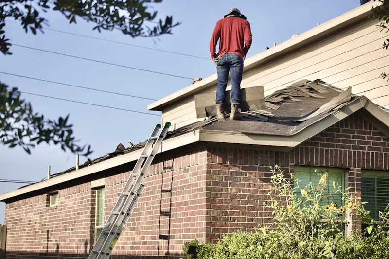 Professional roofer working on a residential roof in Skyline Boulevard